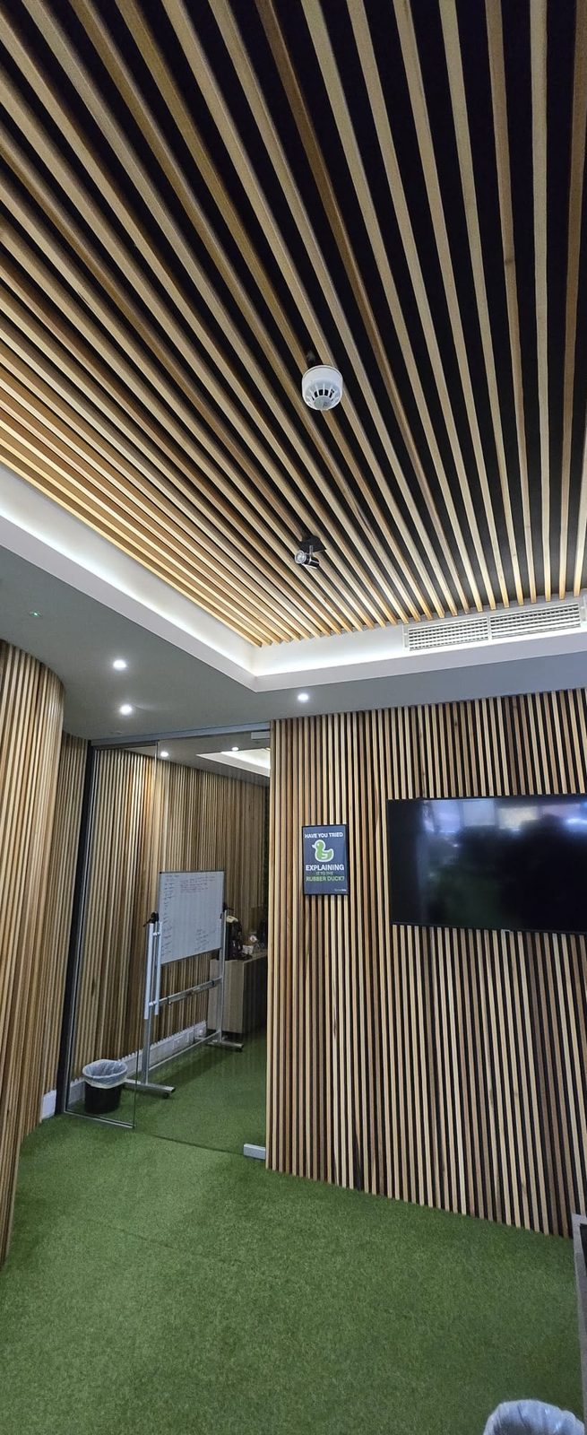 Slatted timber ceiling and walls with recessed feature lighting